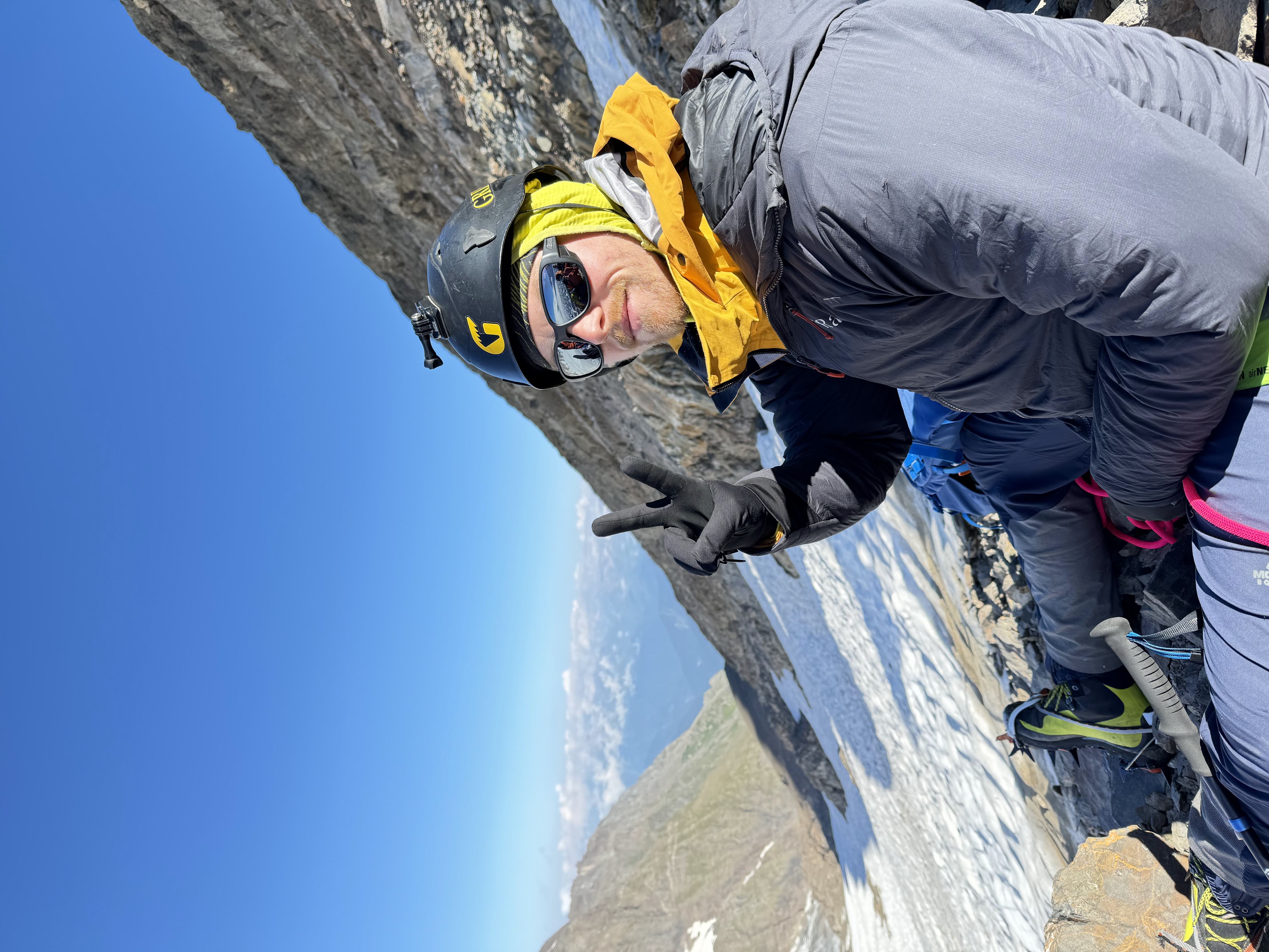 Will on a high alpine ridge with glacier behind